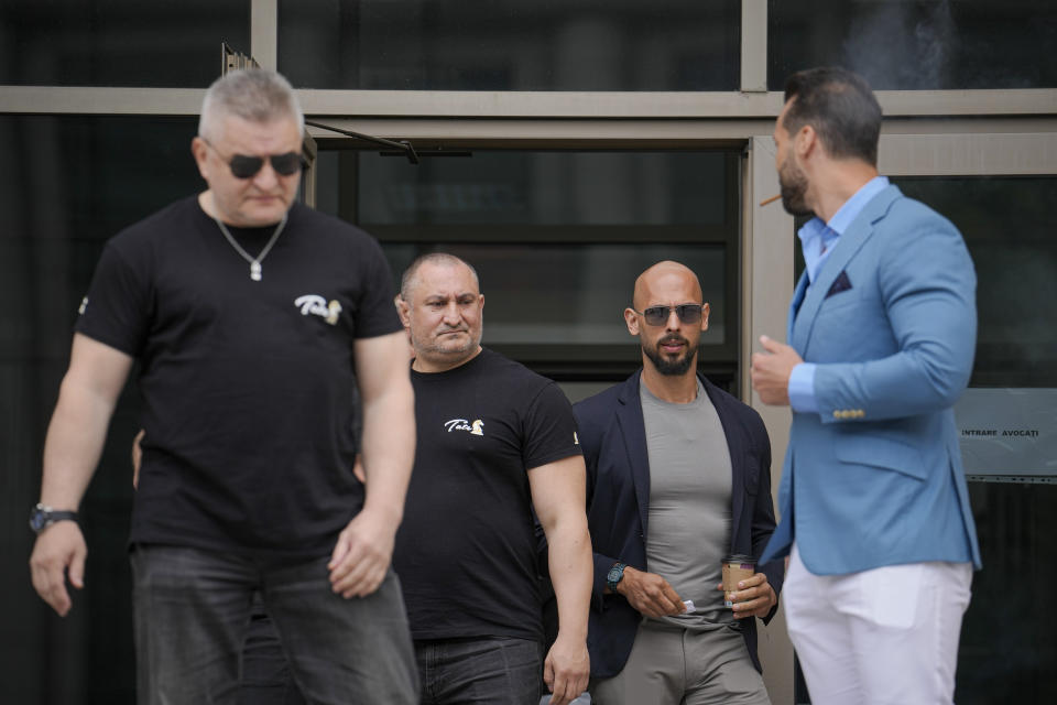 Andrew Tate and his brother Tristan, right, leave the Bucharest Tribunal in Bucharest, Romania, Wednesday, May 8, 2024. A court in Romania's capital ruled on April 26, that a trial could start but did not set a date for the trial to begin in the case of influencer Andrew Tate, who is charged with human trafficking, rape and forming a criminal gang to sexually exploit women. (AP Photo/Vadim Ghirda)