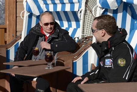 Russian President Vladimir Putin (L) and Prime Minister Dmitry Medvedev chat during their visit to the "Laura" cross country ski and biathlon centre in the resort of Krasnaya Polyana near Sochi January 3, 2014. REUTERS/Alexei Nikolskiy/RIA Novosti/Kremlin