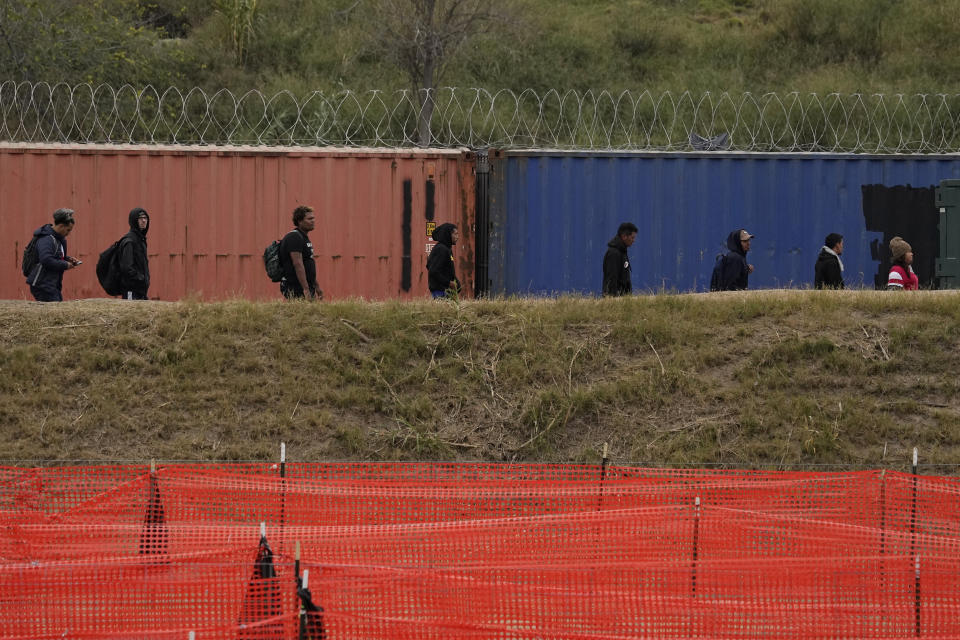 Migrants are led to a processing area after they crossed the Rio Grande from Mexico into the U.S. Thursday, Jan. 4, 2024, in Eagle Pass, Texas. According to U.S. officials, a Mexican enforcement surge has contributed to a sharp drop in illegal entries to the U.S. in recent weeks. (AP Photo/Eric Gay)