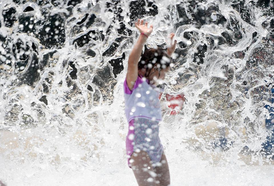 Nine-year-old Anastasia Olson plays in the water at Collier Pool on July 4, 2020.