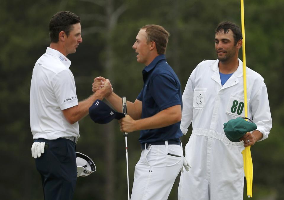 Jordan Spieth of the U.S. shakes hands with Justin Rose of Britain (L) on the 18th green after Spieth during the final round of the Masters golf tournament at the Augusta National Golf Course in Augusta, Georgia April 12, 2015. REUTERS/Brian Snyder