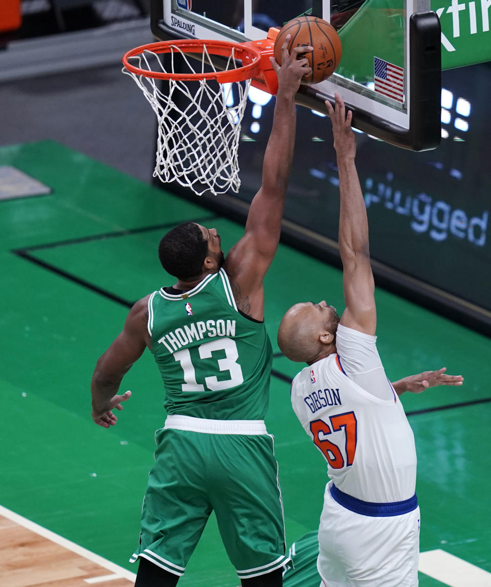 Boston Celtics center Tristan Thompson (13) blocks a shot by New York Knicks center Taj Gibson (67) during the first half of an NBA basketball game, Wednesday, April 7, 2021, in Boston. (AP Photo/Charles Krupa)