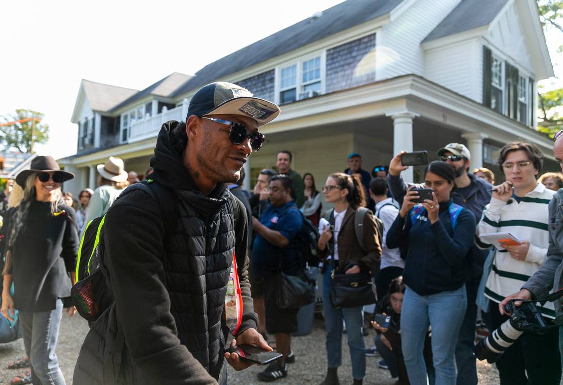 A Venezuelan migrant is led onto a bus at St. Andrews Episcopal Church on Friday, Sept. 16, 2022, in Edgartown, Mass on the island of Marthas Vineyard. A group of 48 migrants was flown to the island from Texas earlier this week, leaving them stranded. They are now being transferred to a military base in Cape Cod.