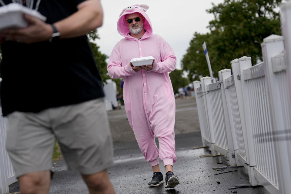 Tommy Moore, of the Usual Saucepects barbecue team, delivers a sample of his team's ribs to judges at the World Championship Barbecue Cooking Contest, Saturday, May 18, 2024, in Memphis, Tenn. (AP Photo/George Walker IV)