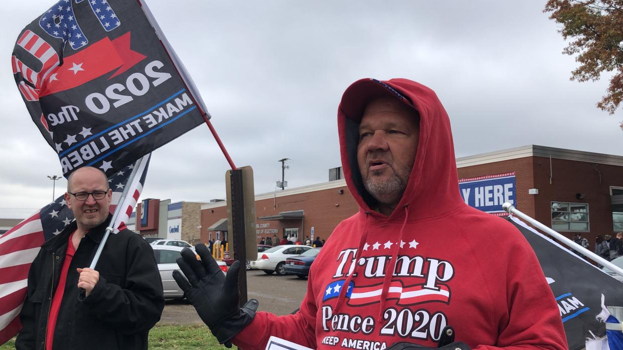 John Doug Wright demonstrates support for President Donald Trump during early voting in October 2020 at the Stark County Board of Elections in Canton.