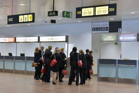 Members of staff stand in the departure hall after a ceremony at Brussels Airport as it reopens 40 days after deadly attacks in Zaventem, Belgium, May 1, 2016. REUTERS/Eric Vidal