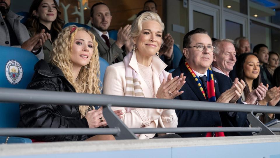 Rebecca sitting in the stands cheering in a scene from "Ted Lasso"