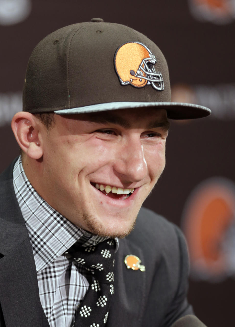 Cleveland Browns quarterback Johnny Manziel, from Texas A&M, laughs during his introductory news conference at the NFL football team's facility in Berea, Ohio Friday, May 9, 2014. The Browns selected Manziel with the 22nd overall pick in Thursday's draft. (AP Photo/Tony Dejak)