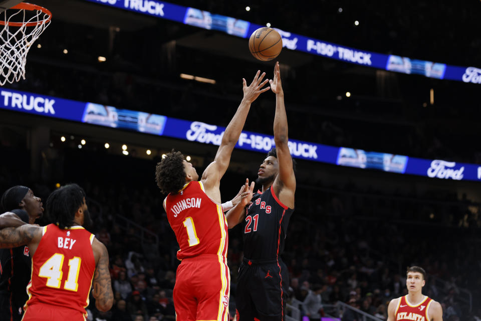 Toronto Raptors forward Thaddeus Young (21) goes up for a basket against Atlanta Hawks forward Jalen Johnson (1) during the first half of an NBA basketball game Sunday, Jan. 28, 2024, in Atlanta. (Miguel Martinez/Atlanta Journal-Constitution via AP)