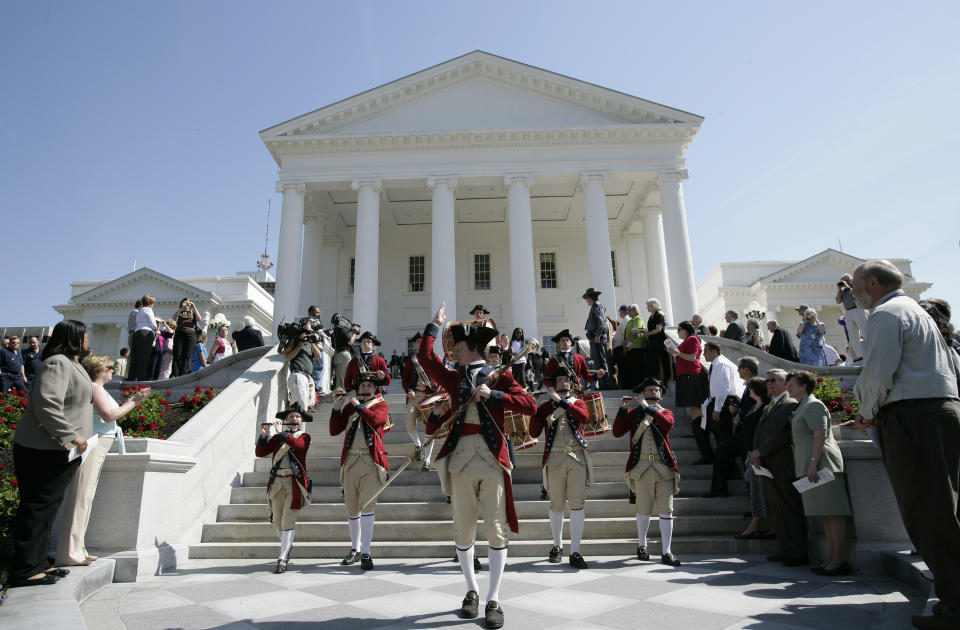 FILE - In this Tuesday May 1, 2007 file photo, the Colonial Williamsburg Fife and Drum Corp leads a procession during dedication ceremonies for the newly renovated Capitol at the Capitol in Richmond, Va. The state Capitol building, designed by Thomas Jefferson in the Monumental Classical style, has housed state government since 1788. The wings of the building were added between 1904 and 1906. The Capitol reopened in 2007 after a $104.5 million restoration and expansion project that began in 2004. Statues of Virginia historic figures dot the grounds. (AP Photo/Steve Helber)