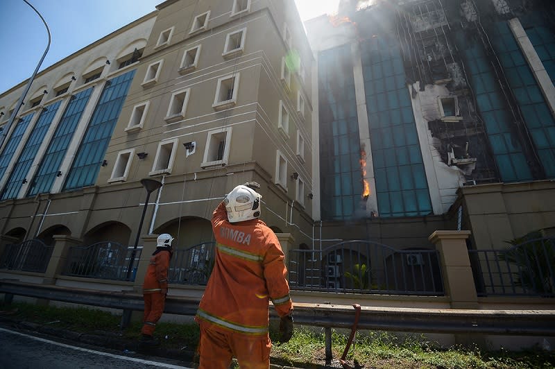 Fire and Rescue department personnel attempt to put out the fire at the EPF building at Jalan Gasing in Petaling Jaya February 13, 2018. — Picture by Mukhriz Hazim