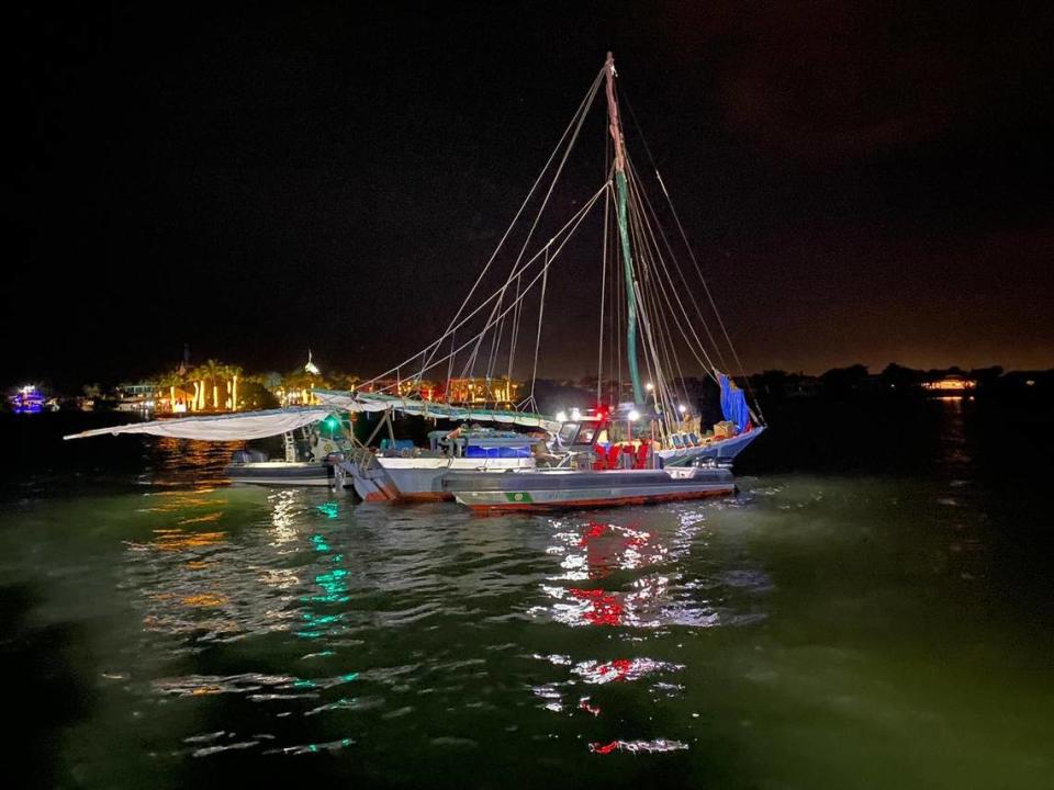 Fire rescue personnel tend to a migrant boat carrying up to 100 people from Haiti early Monday morning, Jan. 10, 2022, off Key Largo.