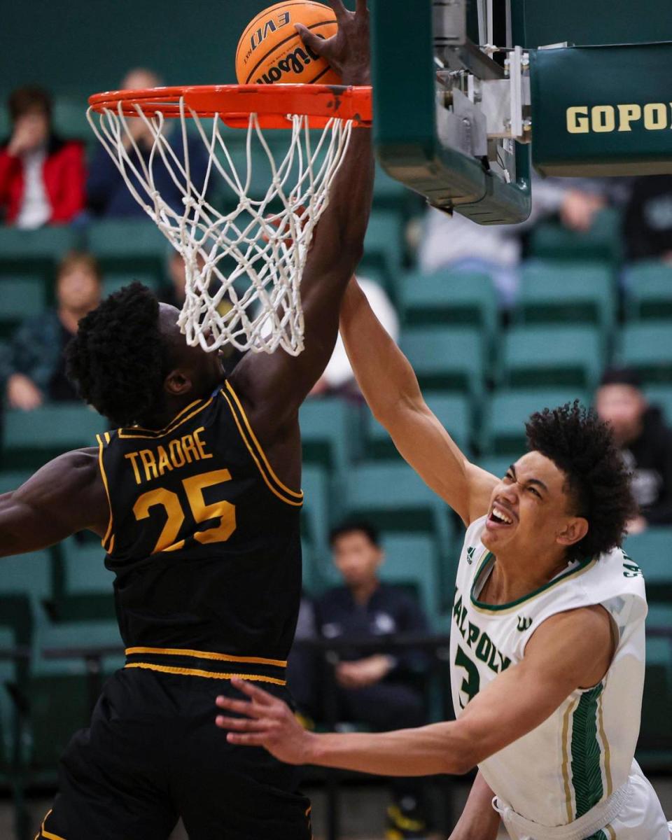 Kobe Sanders is blocked by Aboubacar Traore. Long Beach state won 89-82 at Cal Poly’s Mott gym Jan. 4, 2024. David Middlecamp/dmiddlecamp@thetribunenews.com