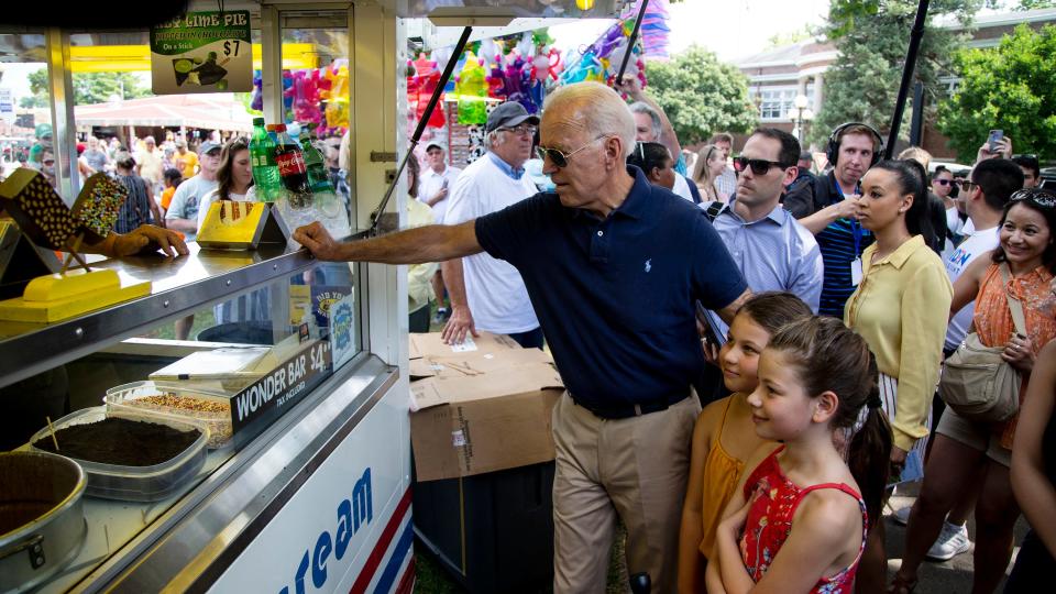 Former Vice President Joe Biden buys an ice cream Wonder Bar for himself and sisters Grace and Noelle Beasley, of Urbandale, on the first day of the Iowa State Fair on Thursday, Aug. 8, 2019, in Des Moines, Iowa.