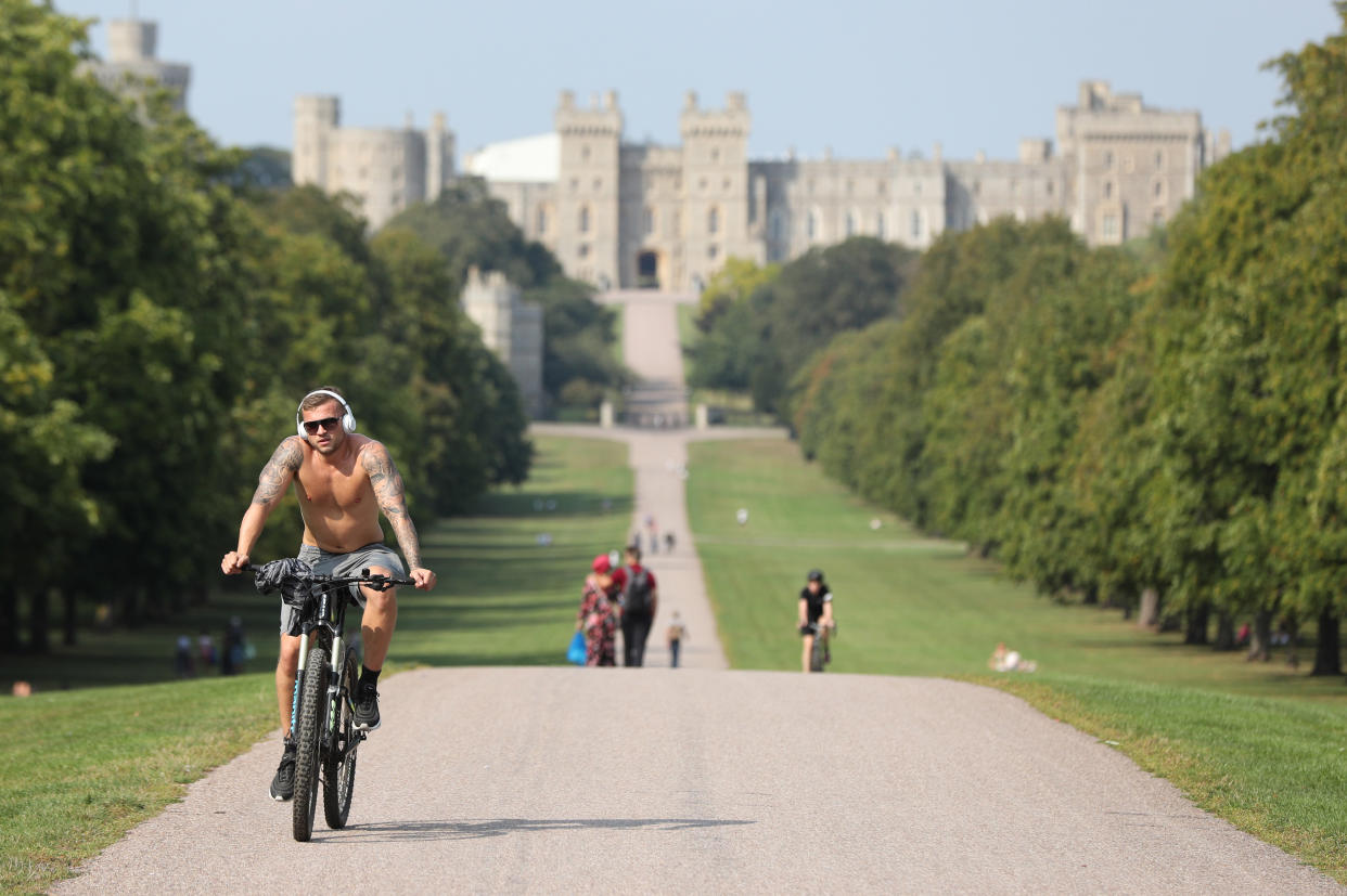 A cyclist travels along the Long Walk, Windsor, Berkshire, in the sunshine following the hottest August Bank Holiday Monday on record, where temperatures reached 33.2C. The heatwave is set to continue for some parts of the UK after the record-breaking bank holiday weather. (Photo by Jonathan Brady/PA Images via Getty Images)