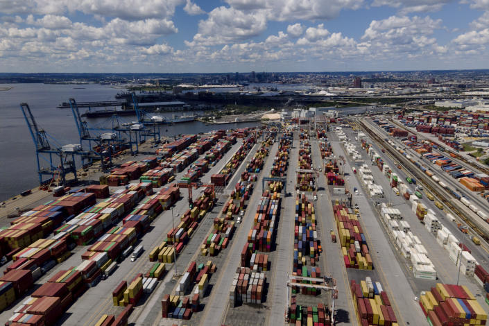 Shipping containers are stacked together at the Port of Baltimore, Friday, Aug. 12, 2022, in Baltimore. Six months into the war in Ukraine, American companies — including federal contractors — continue to buy everything from birch wood flooring to weapons-grade titanium from major Russian corporations. (AP Photo/Julio Cortez)