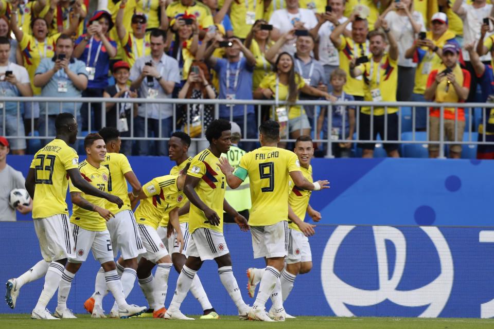 Colombia’s players celebrate after team mate Yerry Mina scored his side’s opening goal and sent them through to the round of 16