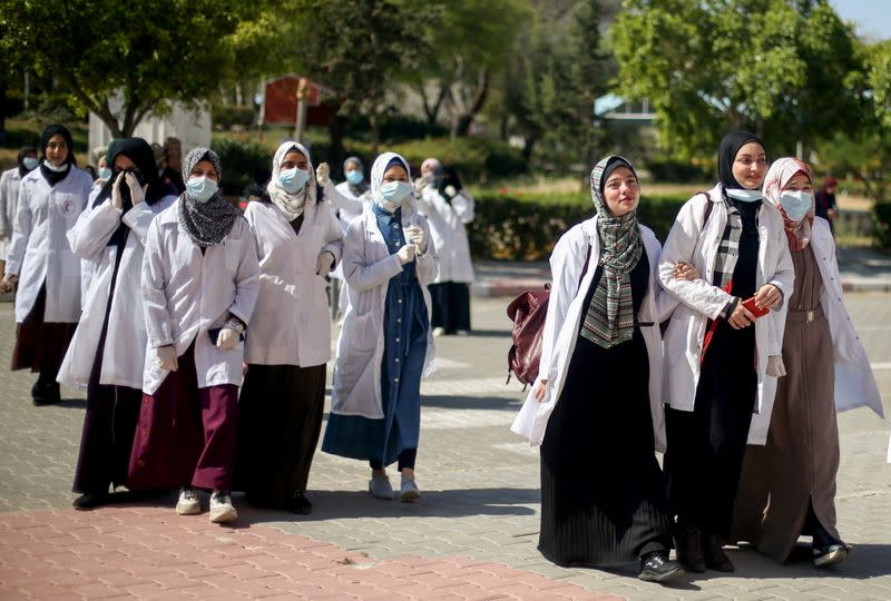 Palestinian students walk at a university in Khan Younis in the southern Gaza Strip