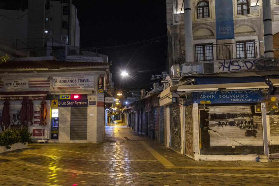 This photo shows a view of central Monastiraki square in Athens, Greece, Sunday, Oct. 25, 2020. Greece's government has imposed a nightly curfew in greater Athens and other areas with high infection rates as well as a mask requirement. (AP Photo/Yorgos Karahalis)