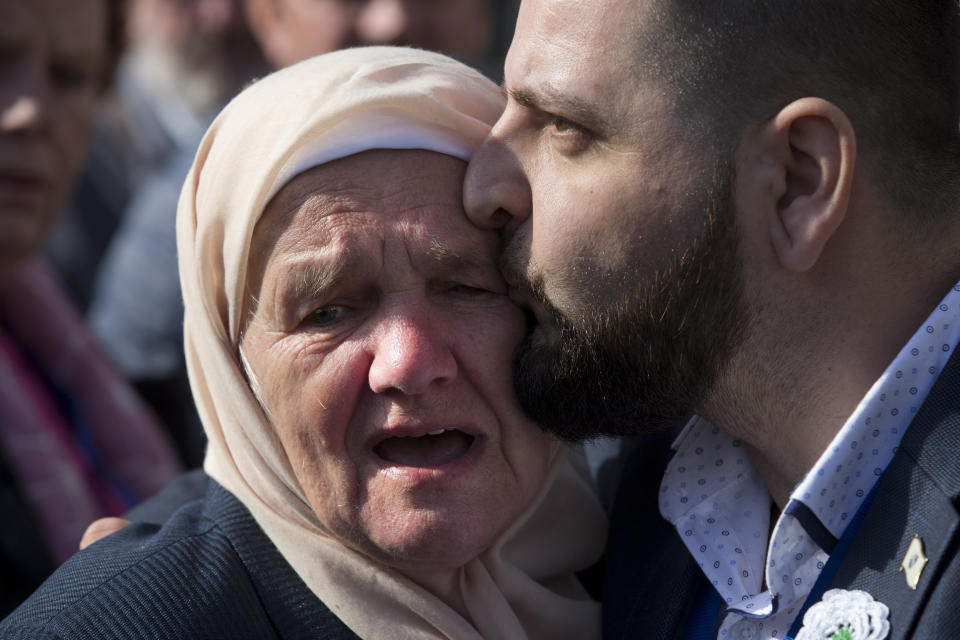 A crying woman with the Mothers of Srebrenica is hugged after the court upheld the convictions of former Bosnian Serb leader Radovan Karadzic at International Residual Mechanism for Criminal Tribunals in The Hague, Netherlands, Wednesday, March 20, 2019. Nearly a quarter of a century since Bosnia's devastating war ended, Karadzic heard the final judgment upholding 2016 convictions for genocide, crimes against humanity and war crimes, and increased his 40-year sentence to life. (AP Photo/Peter Dejongl)