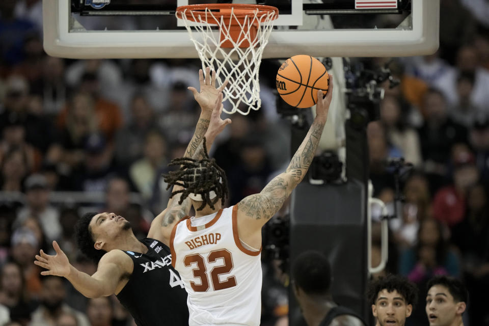 Texas forward Christian Bishop shoots over Xavier forward Cesare Edwards in the first half of a Sweet 16 college basketball game in the Midwest Regional of the NCAA Tournament Friday, March 24, 2023, in Kansas City, Mo. (AP Photo/Charlie Riedel)