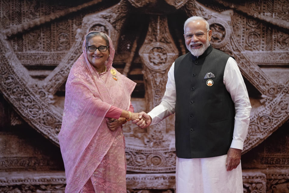 Indian Prime Minister Narendra Modi, right, shakes hand with Bangladesh Prime Minister Sheikh Hasina upon her arrival at Bharat Mandapam convention centre for the G20 Summit in New Delhi, India, Saturday, Sept. 9, 2023. (AP Photo/Evan Vucci, Pool)