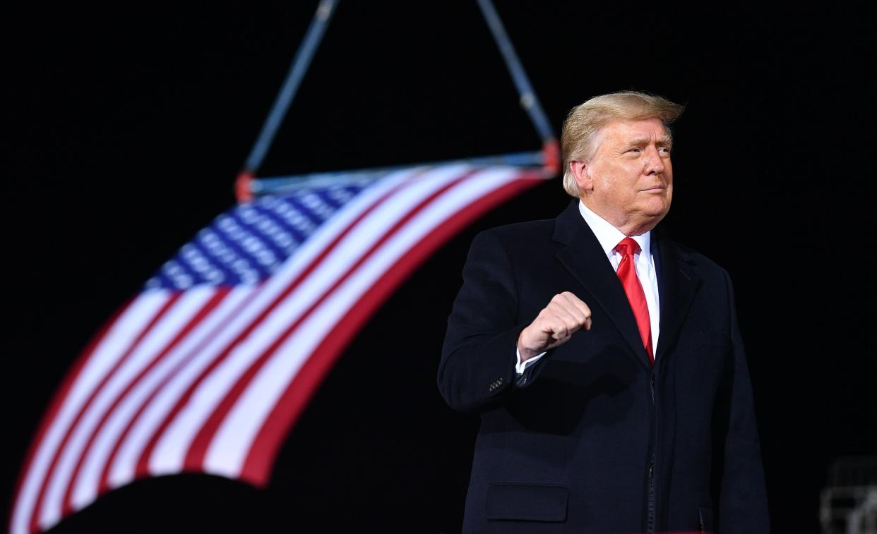 <p>Donald Trump used a campaign rally in Georgia for two GOP Senate candidates to threaten his VP and GOP lawmakers to reject the Electoral College result.</p> (AFP via Getty Images)