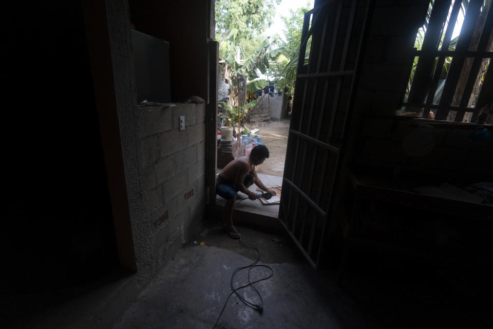 A resident works on his home in the October 2 squatter settlement in Tulum, Quintana Roo state, Mexico, Thursday, August 4, 2022. The attorney general of Quintana Roo, Oscar Montes de Oca, vows to evict the squatters, saying he has the cort orders. (AP Photo/Eduardo Verdugo)