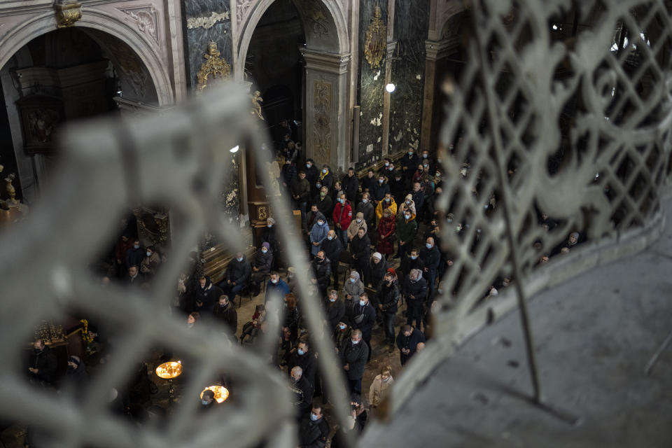 Christian worshipers attend a Sunday mass in the Saints Peter and Paul Garrison Church in Lviv, western Ukraine, Sunday, March 6, 2022. (AP Photo/Bernat Armangue)