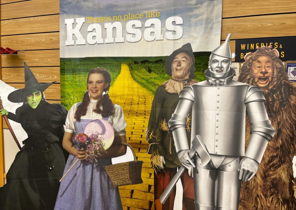 Cardboard version of characters from "The Wizard of Oz" film greet travelers inside the Kansas welcome center on Interstate 70 near Kanorado. The banner in the background features the state's former tourism slogan, there's no place like Kansas.