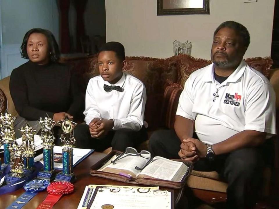 &nbsp;Christian Philon, 12, and his parents, Gwen and Earvin Philon. (Photo: <a href="https://www.wsbtv.com/news/local/henry-county/unjust-punishment-boy-suspended-for-unwittingly-using-counterfeit-money-in-lunch-line/905598610" target="_blank">WSB-TV</a>)