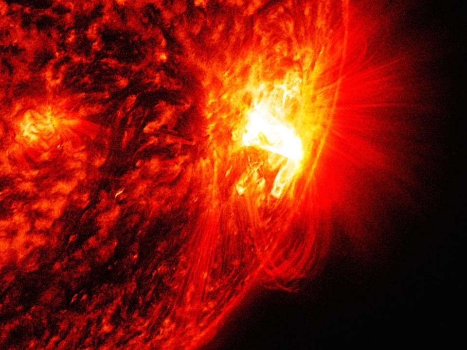 A flare is shown on the surface of the sun.