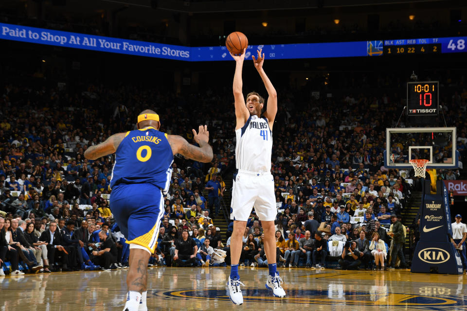 OAKLAND, CA - MARCH 23: Dirk Nowitzki #41 of the Dallas Mavericks shoots three point basket against the Golden State Warriors on March 23, 2019 at ORACLE Arena in Oakland, California. NOTE TO USER: User expressly acknowledges and agrees that, by downloading and or using this photograph, user is consenting to the terms and conditions of Getty Images License Agreement. Mandatory Copyright Notice: Copyright 2019 NBAE (Photo by Noah Graham/NBAE via Getty Images)