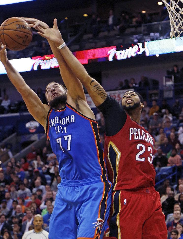 Oklahoma City Thunder center Joffrey Lauvergne (77) grabs a rebound against New Orleans Pelicans forward Anthony Davis (23) during the second half of an NBA basketball game in New Orleans, Wednesday, Dec. 21, 2016. (AP Photo/Max Becherer)