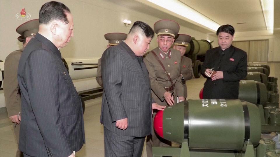 A screen grab shows North Korean leader Kim Jong Un inspecting nuclear warheads at an undisclosed location in this undated still image used in a video.