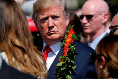 U.S. President Donald Trump sports a flower lei he was given as he and first lady Melania Trump arrive aboard Air Force One at Hickam Air Force Base, Hawaii, U.S. November 3, 2017. REUTERS/Jonathan Ernst