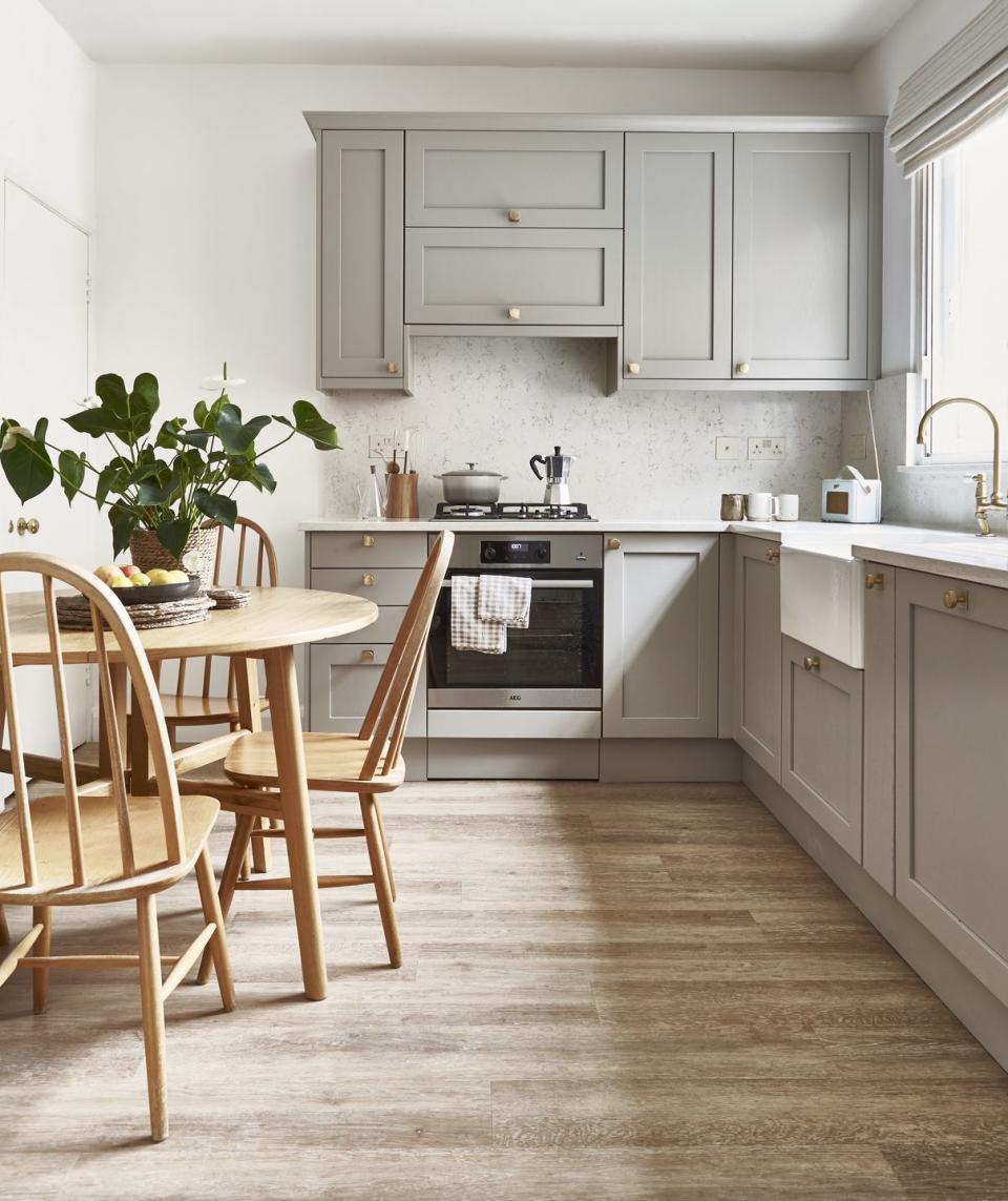 a soft grey kitchen with a wooden table and chairs