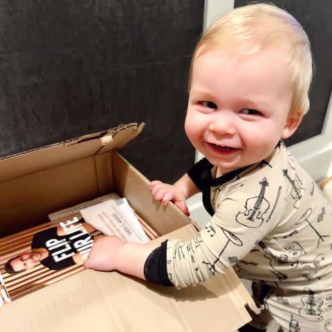 <p>Heather Rae El Moussa/Instagram</p> Heather Rae El Moussa and Tarek El Moussa's son Tristan with copies of Tarek's book 'Flip Your Life'