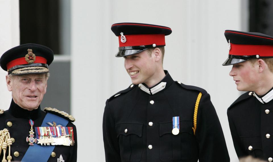 Prince Philip talks with his grandsons Prince William and Prince Harry at the Sovereign's Parade at Sandhurst Military Academy on April 12, 2006, in Surrey, England. (Photo: Tim Graham via Getty Images)