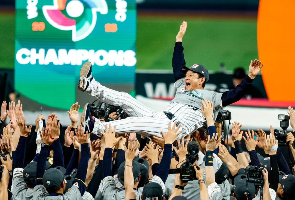 Japan manager Hideki Kuriyama (89) is tossed in the air after Japan defeats the United States during the World Baseball Classic Championship Game at loanDepot Park in Miami, Fla. on Tuesday, March 21, 2023. 
