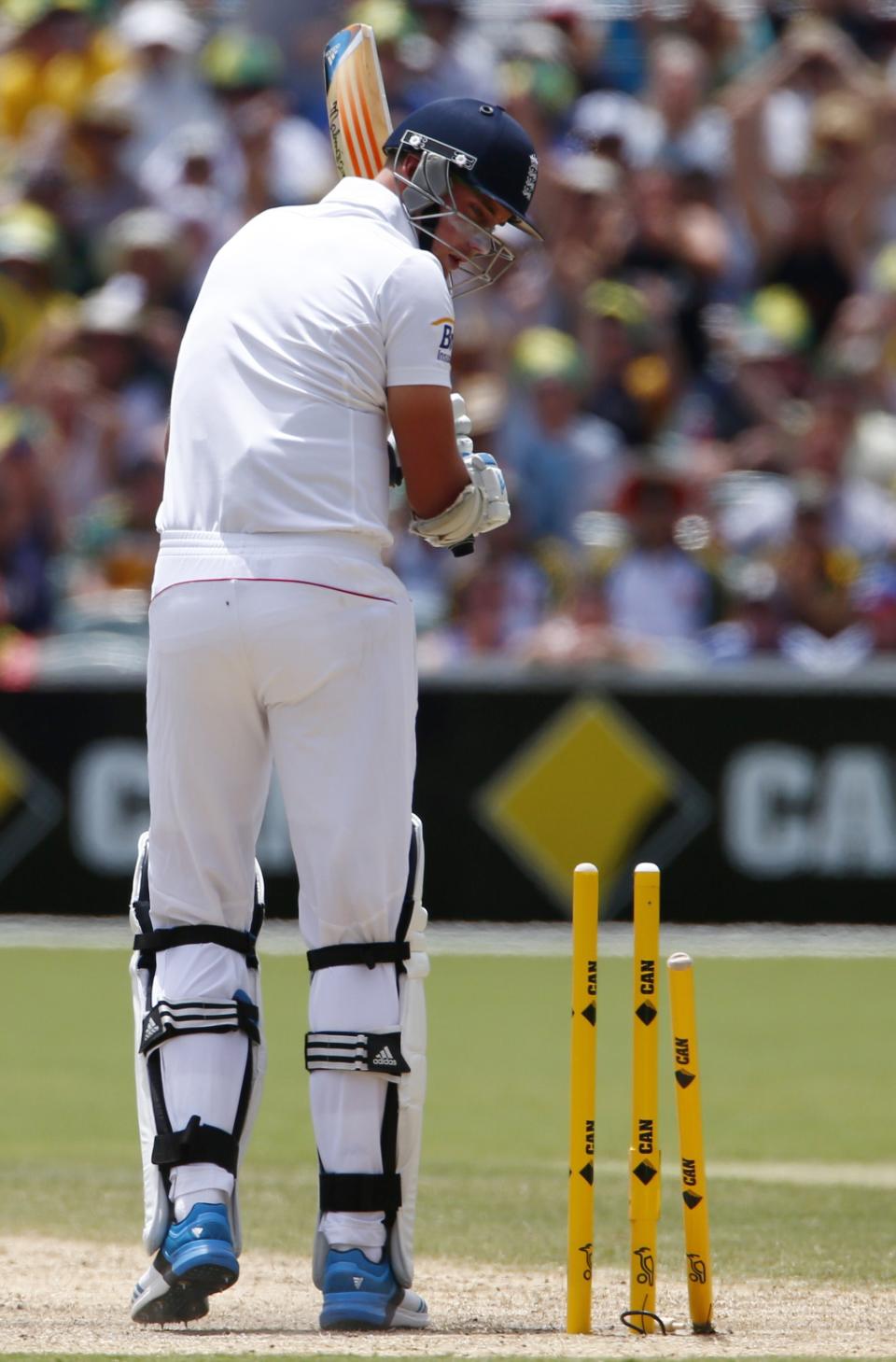 England's Stuart Broad looks at the stumps after he was bowled out by Australia's Mitchell Johnson during the third day's play in the second Ashes cricket test at the Adelaide Oval December 7, 2013.