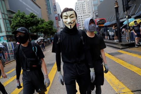 Masked anti-government protesters attend a demonstration in Tsim Sha Tsui district, in Hong Kong