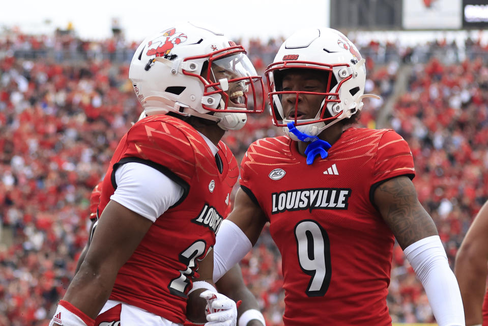 LOUISVILLE, KENTUCKY - OCTOBER 28: Jawhar Jordan #25 of the Louisville Cardinals celebrates a touchdown with Ahmari Huggins-Bruce #9 during the first half in the game against the Duke Blue Devils at Cardinal Stadium on October 28, 2023 in Louisville, Kentucky. (Photo by Justin Casterline/Getty Images)