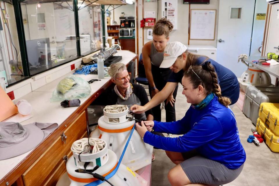 University of Miami oceanography professor Lisa Beal (far left) reviews mooring instruments to be deployed in the Florida current with Allie Cook, a UM undergraduate student, and Rachel Sampson and Paloma Cartwright, Ph.D. students in ocean sciences and members of the Beal lab.