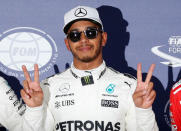 Formula One F1 - Japanese Grand Prix 2017 - Suzuka Circuit, Japan - October 7, 2017. Mercedes' Lewis Hamilton of Britain celebrates after getting pole position in qualifying. REUTERS/Toru Hanai