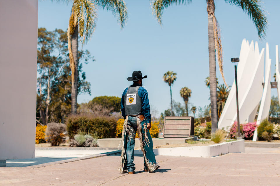 Image of Tre Hosley in his cowboy uniform walking away. (Bethany Mollenkof / for NBC News)
