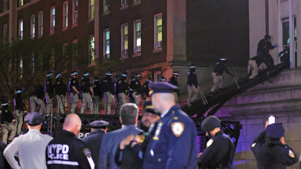 NYPD officers climb a ladder to enter Columbia University's occupied Hamilton Hall. Photo: 30 April 2024