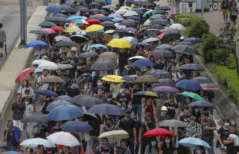 Pro-democracy protesters march in a Hong Kong street Saturday, Aug. 17, 2019. Another weekend of protests is underway in Hong Kong as Mainland Chinese police are holding drills in nearby Shenzhen, prompting speculation they could be sent in to suppress the protests. (AP Photo/Kin Cheung)