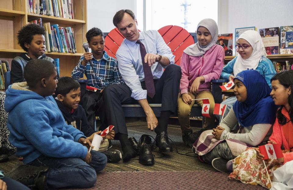 Canada's federal Finance Minister Bill Morneau takes part in the pre-budget ceremony of putting on new shoes at the Nelson Mandela Park Public School in Toronto, Monday March 20, 2017. THE CANADIAN PRESS/Mark Blinch