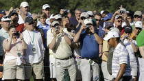 <p>Spectators take photos as Tiger Woods walks down the sixth fairway during a practice round for the Masters golf tournament in Augusta, Ga., Monday, April 5, 2010. The tournament begins Thursday, April, 8. (AP Photo/David J. Phillip) </p>
